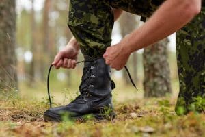 soldier tying shoe