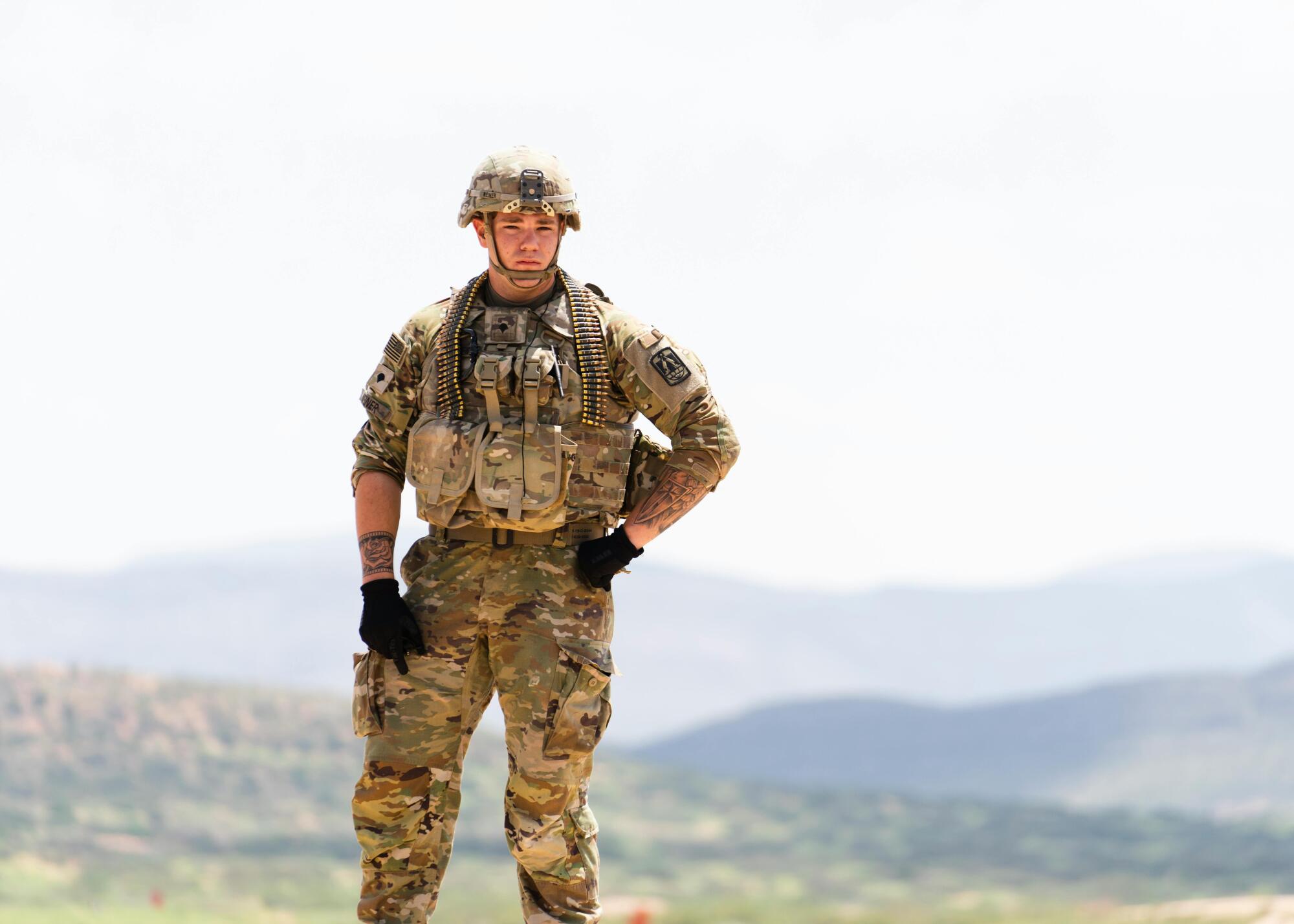 military man standing on a mountain